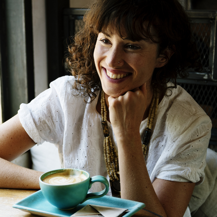 Image of a smiling woman in a conversation