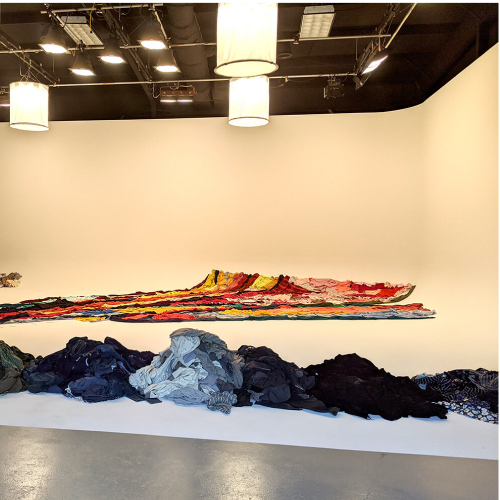 Noah Scalin's material painting artwork seen from the side. He used Old Navy's clothing products as its raw mateiral.