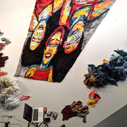 Noah Scalin's material painting artwork seen from above. He used Old Navy's clothing products as its raw mateiral.